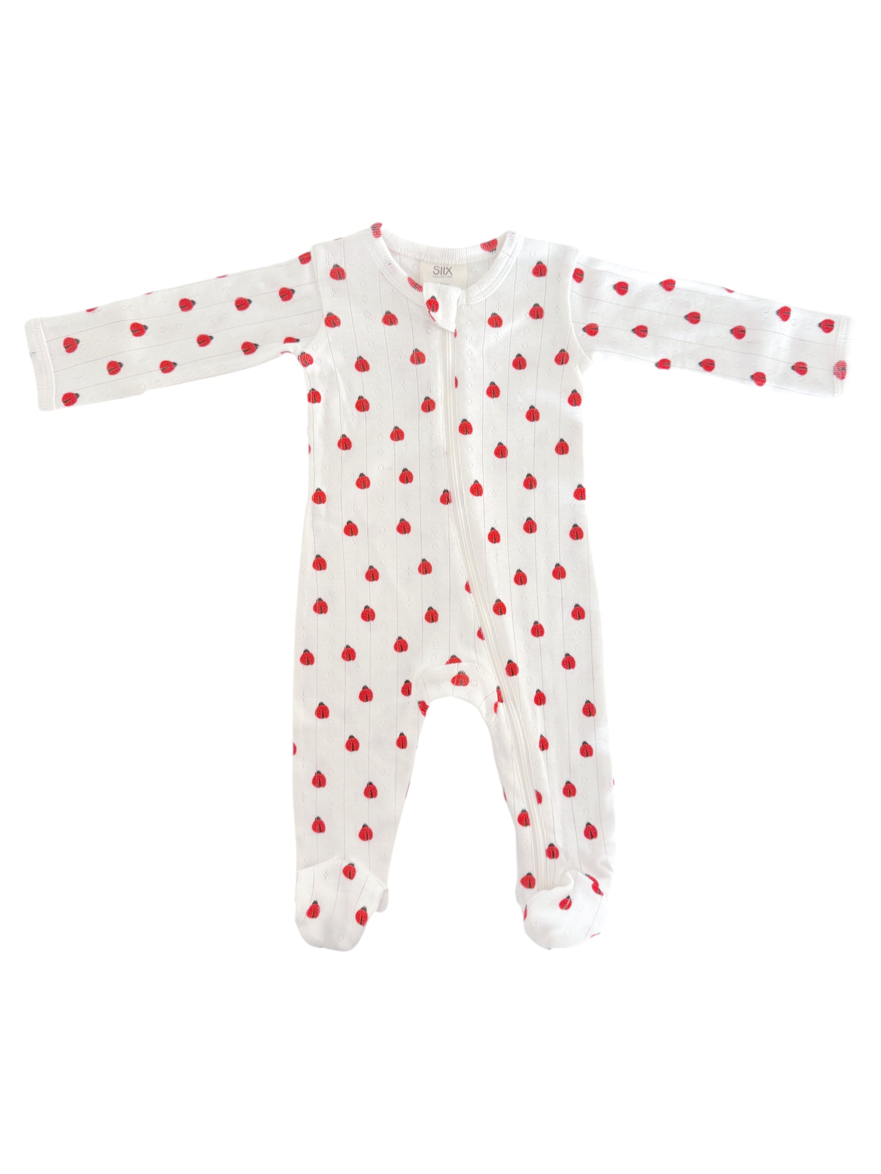White baby onesie adorned with small red hearts, featuring long sleeves and a front zipper.