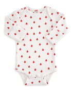White baby bodysuit with red strawberry pattern and long sleeves, featuring snap closures at the bottom.