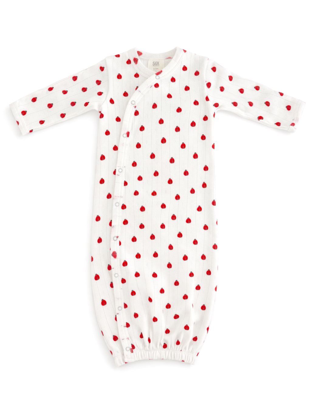 White baby gown with red heart patterns and long sleeves, featuring snap closures along the side for easy dressing.