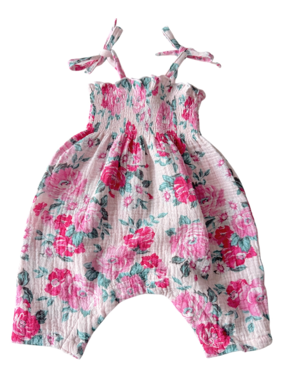 Pink floral baby romper with spaghetti straps and gathered bodice, featuring snap closures at the bottom.