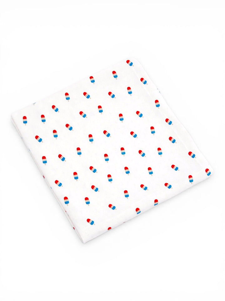 White fabric with a repeating pattern of blue and red ice cream cones.