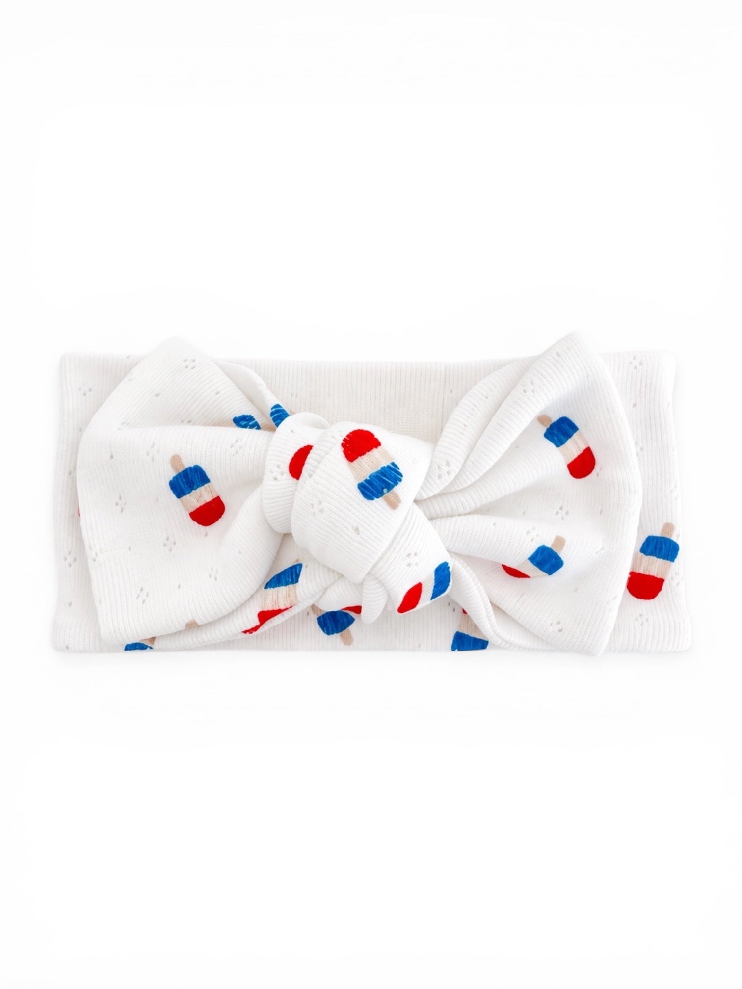 White headband with a large bow featuring red and blue ice pop patterns.