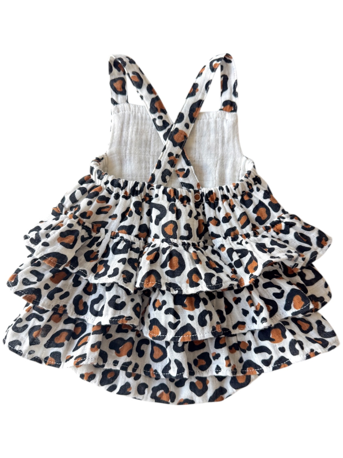 Leopard print dress in white, featuring ruffled tiers and cross-back straps. Ideal for summer fun or casual outings.