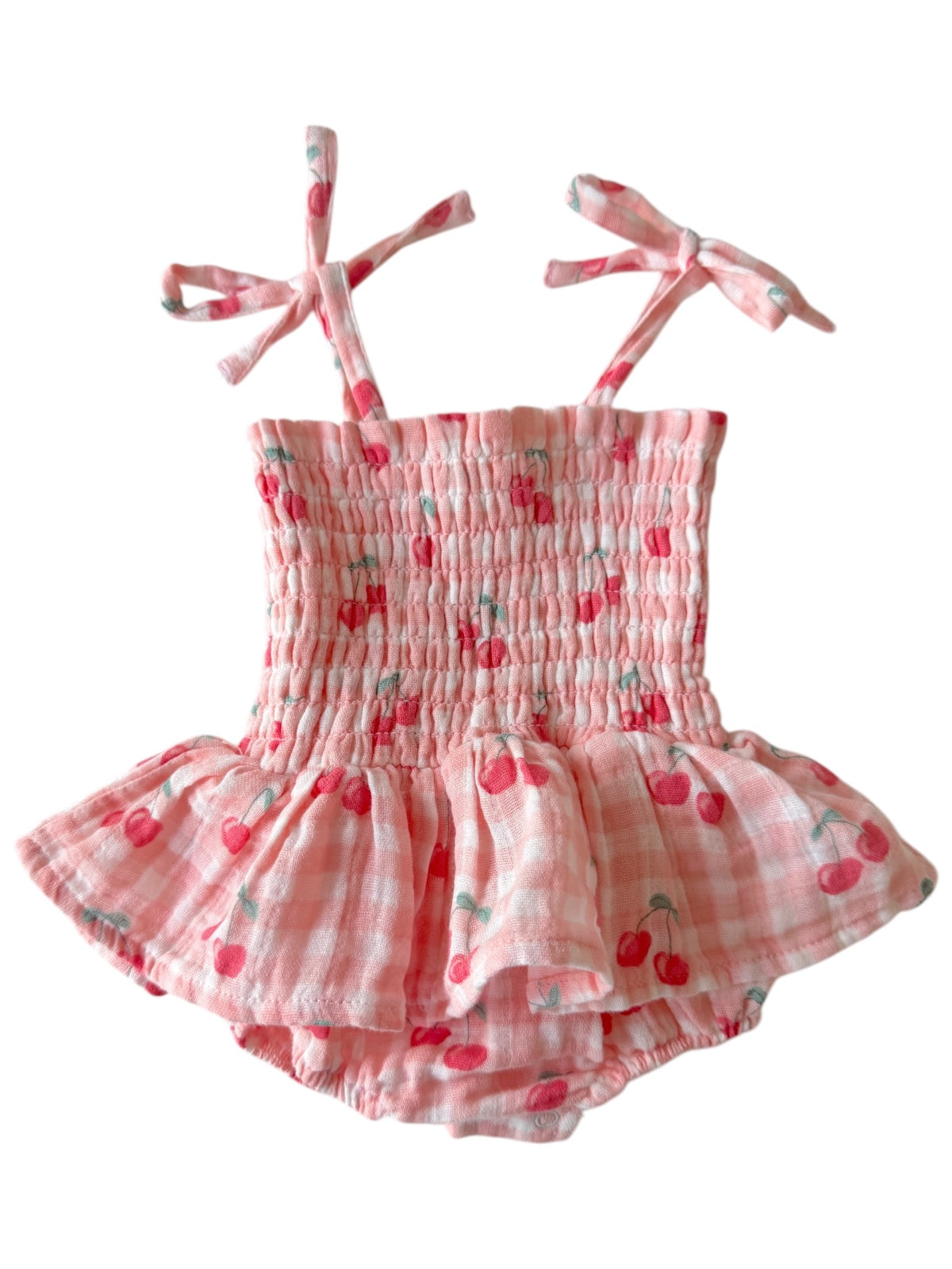 Pink checked toddler dress with cherry print and tie straps, featuring a flared skirt and elastic bodice.