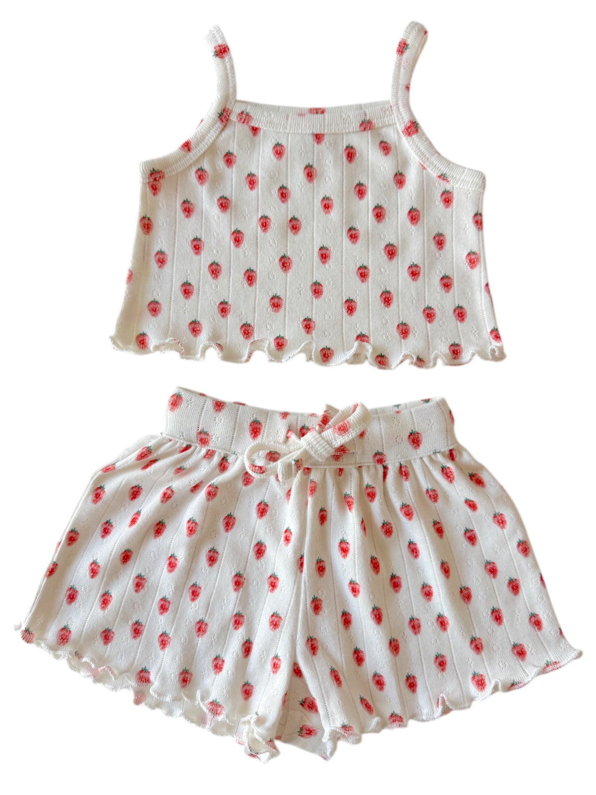 Girls' cute white tank top and shorts set with red strawberry print and ruffled edges. Perfect for summer wear.