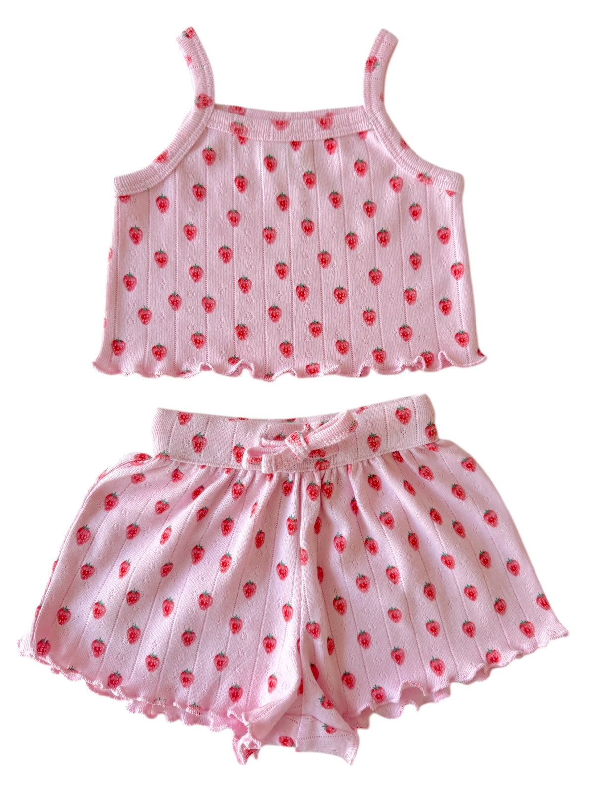 Pink girls' pajama set with strawberry print, featuring a tank top and shorts with ruffled edges.
