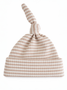 Tan and white checkered baby beanie with a knotted top and soft fabric, ideal for newborns.