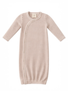 Striped baby gown in soft beige and cream, featuring long sleeves and snap closures for easy dressing.