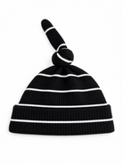Black ribbed beanie hat with white stripes and a knotted top.