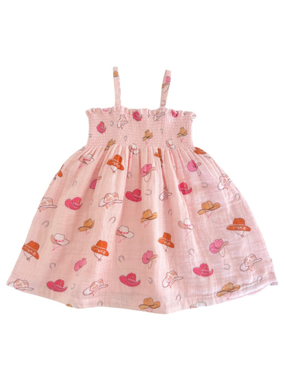Pink dress with spaghetti straps, featuring a playful pattern of colorful hats. Perfect for warm weather.