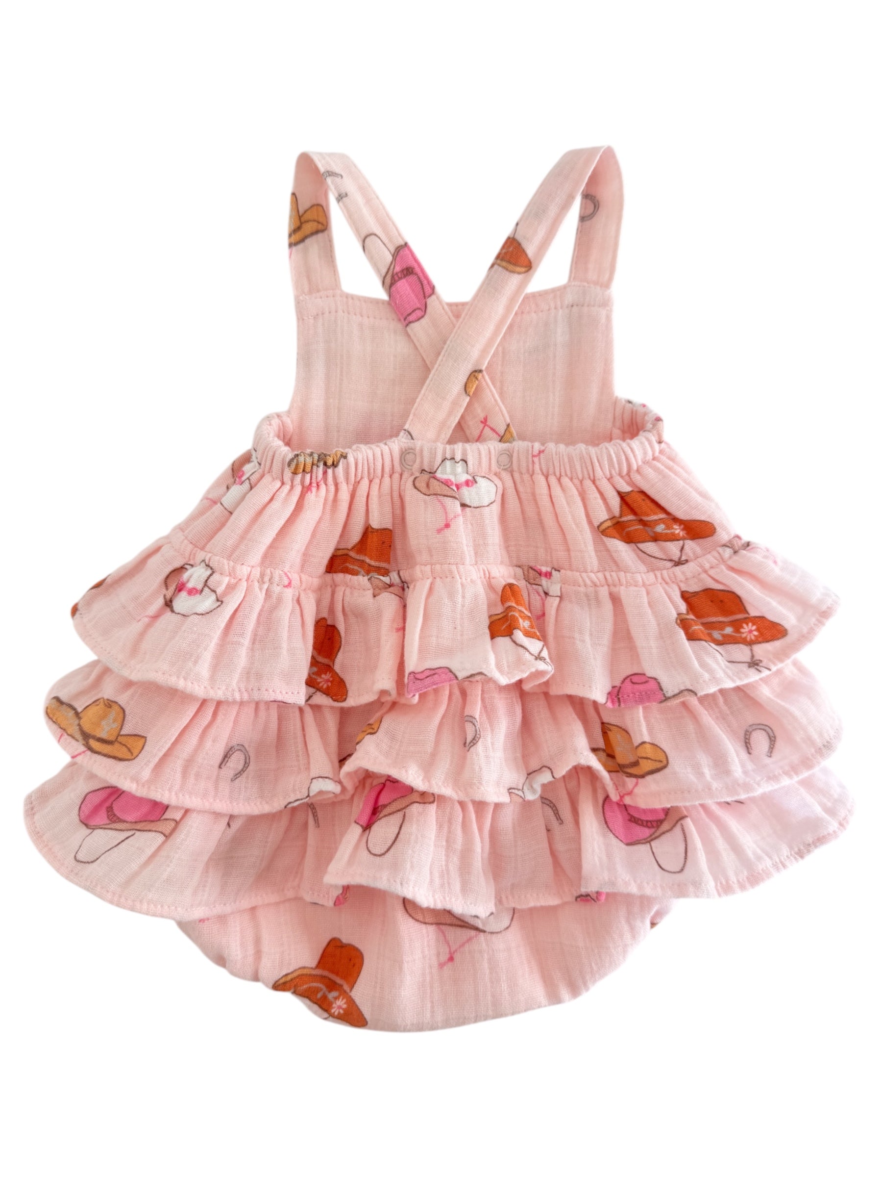 Pink dress with tiered ruffles, featuring colorful hat patterns and adjustable straps. Perfect for warm weather.