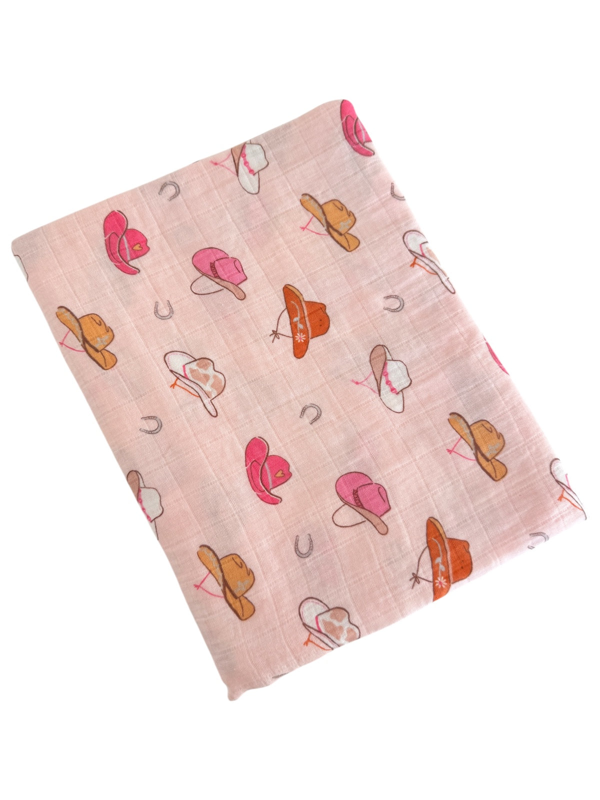 A light pink fabric featuring various colorful hats and horseshoes in a playful pattern.