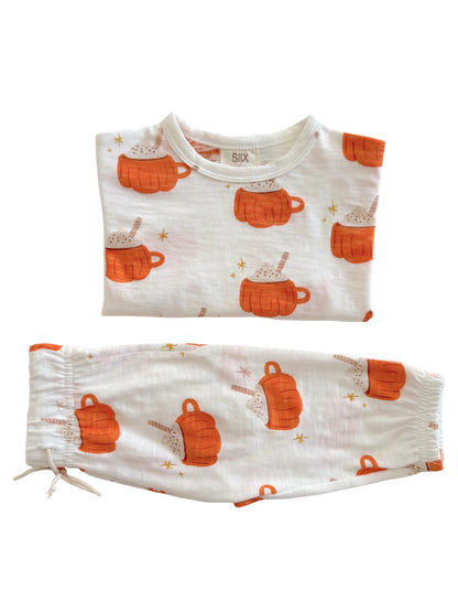 Two-piece pajama set featuring orange mugs and hot chocolate print on white fabric. Ideal for cozy nights.