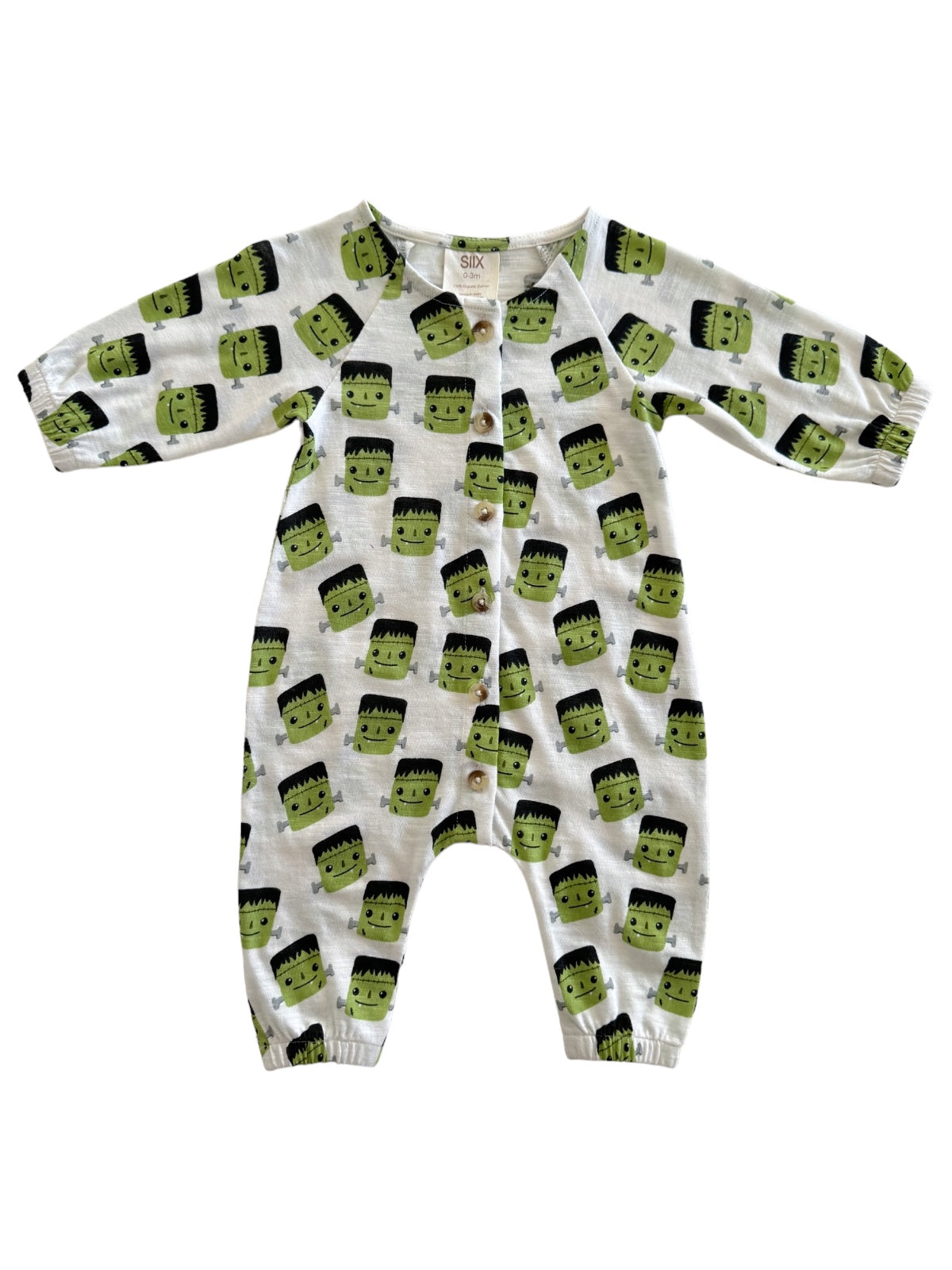 White baby onesie with green Frankenstein faces and black hair, featuring snap buttons down the front and elastic cuffs.