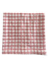 Pink and white checkered fabric laid flat, showcasing a classic gingham pattern. Ideal for home decor or crafting.