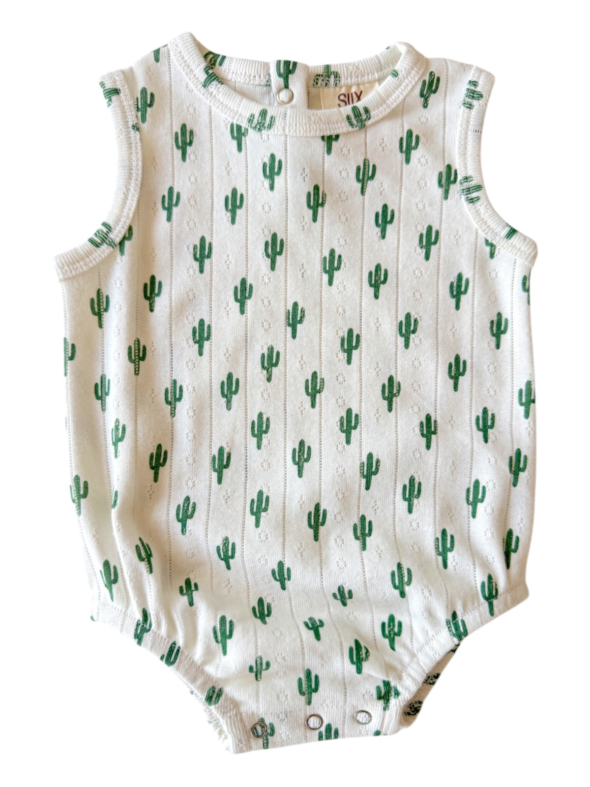 White baby onesie with green cactus pattern, featuring sleeveless design and snaps at the bottom.