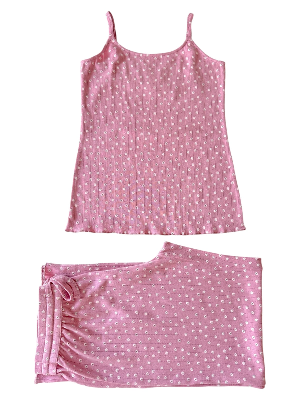 Pink sleepwear set featuring a floral-patterned camisole and matching shorts. Ideal for comfort and relaxation.