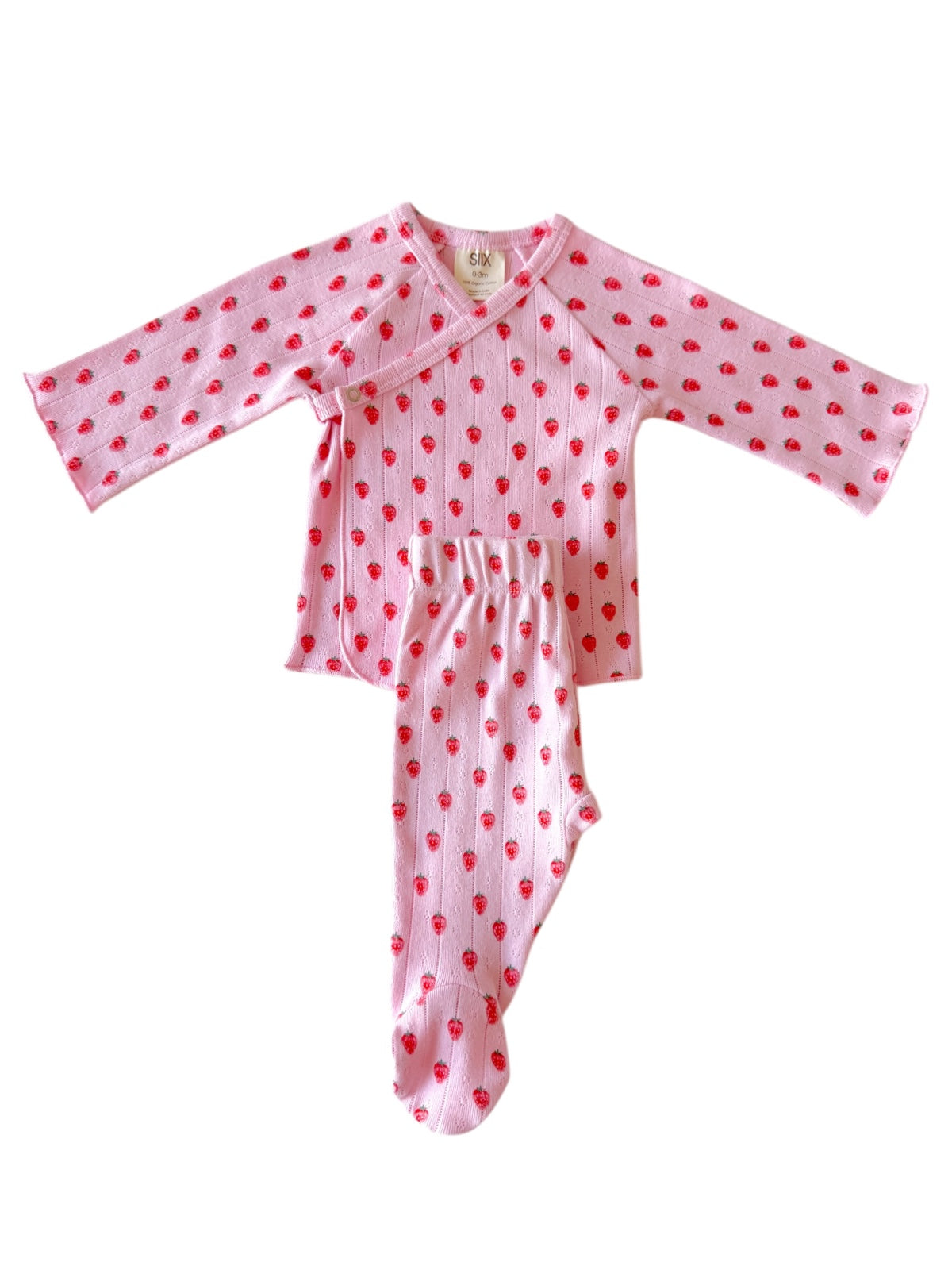Pink baby outfit with long sleeves and strawberry print, featuring a wrap top and footed pants.