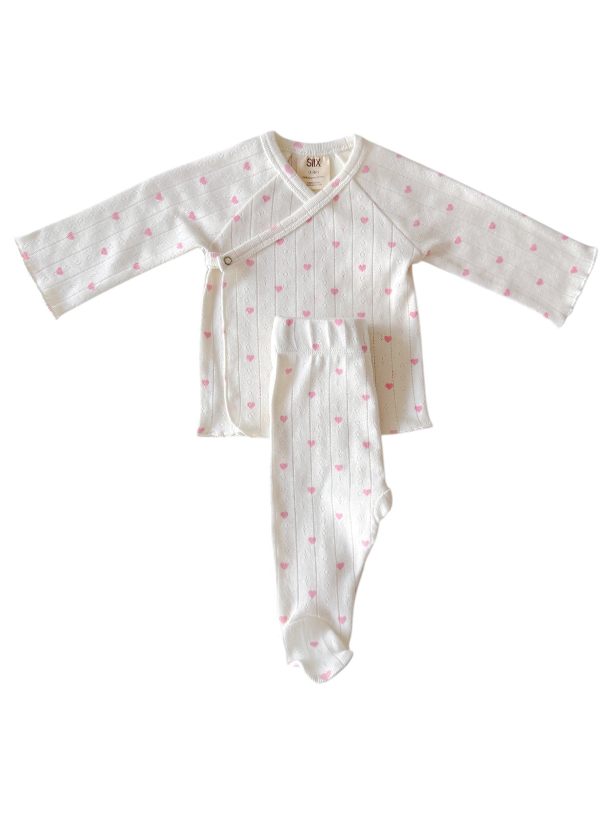 White baby outfit with pink hearts, featuring a long-sleeve top and matching footed pants.