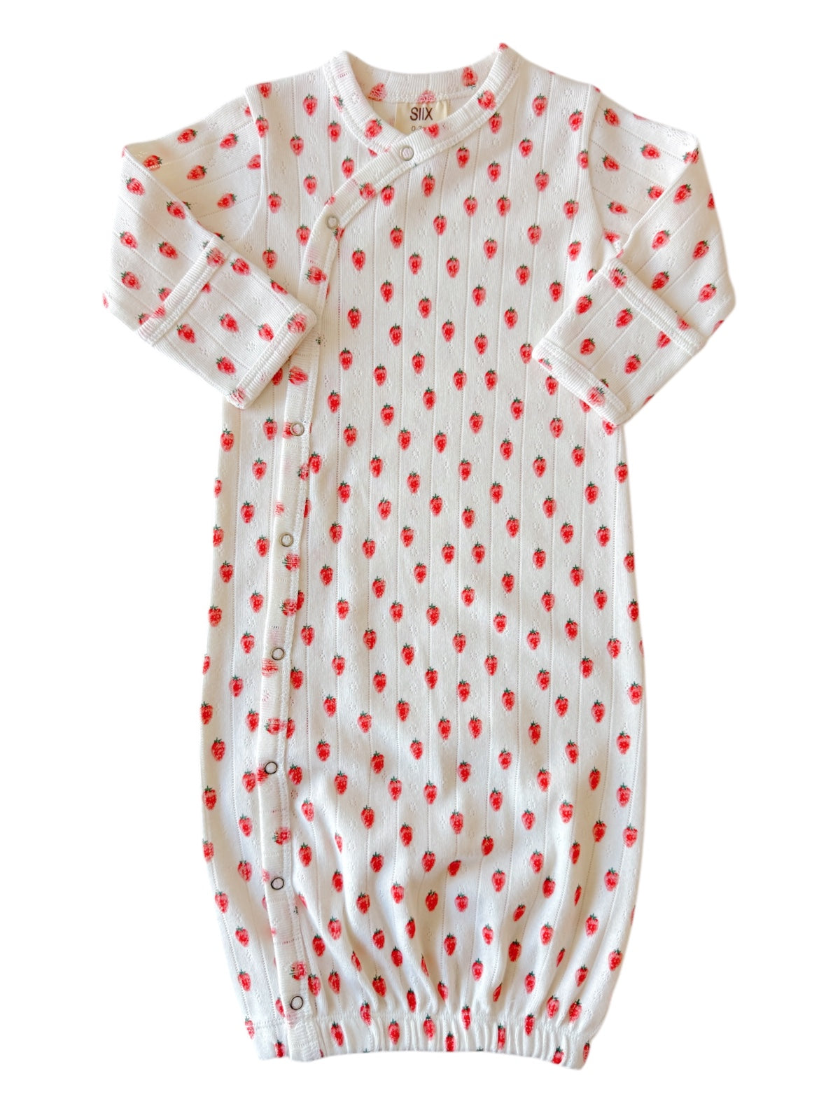 White baby gown with red strawberry pattern, featuring long sleeves and snap buttons along the side.