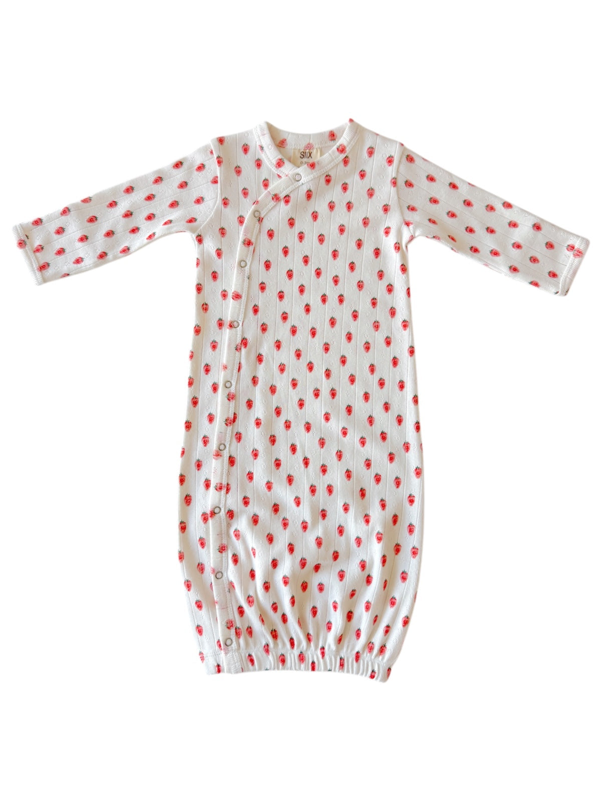 White baby gown with red strawberry patterns and snap buttons, featuring long sleeves and elastic bottom.