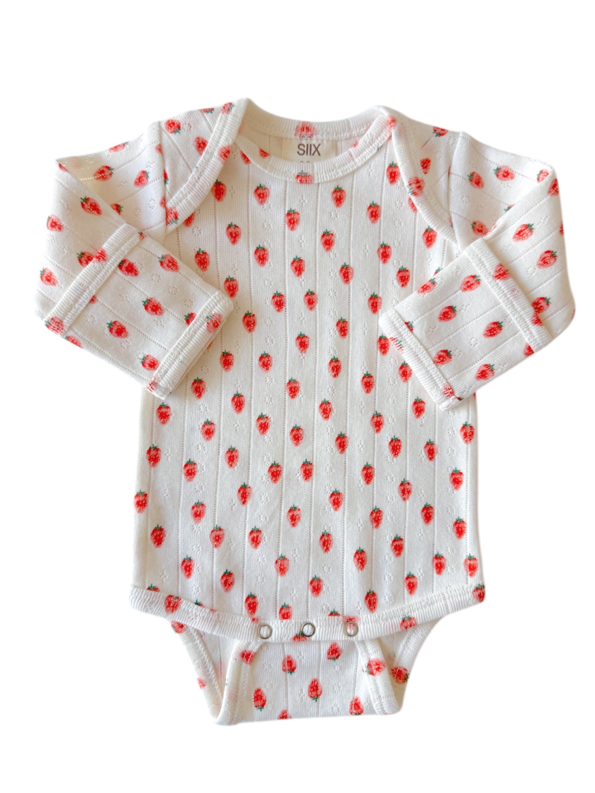 White baby onesie with red strawberry print and long sleeves. Suitable for infants.