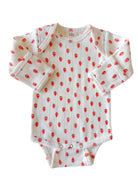 White baby onesie with red strawberry print and long sleeves. Suitable for infants.