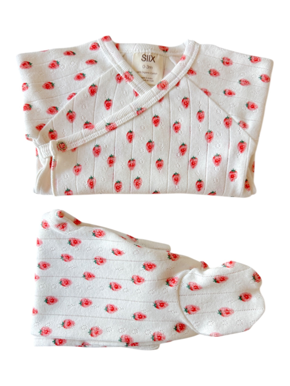 Baby outfit set with white fabric, red strawberry pattern, includes top and matching hat, size 0-3 months.