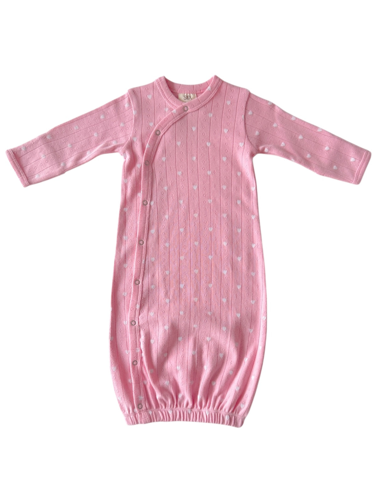 Pink baby gown with white heart patterns, featuring long sleeves and a gathered bottom for comfort.