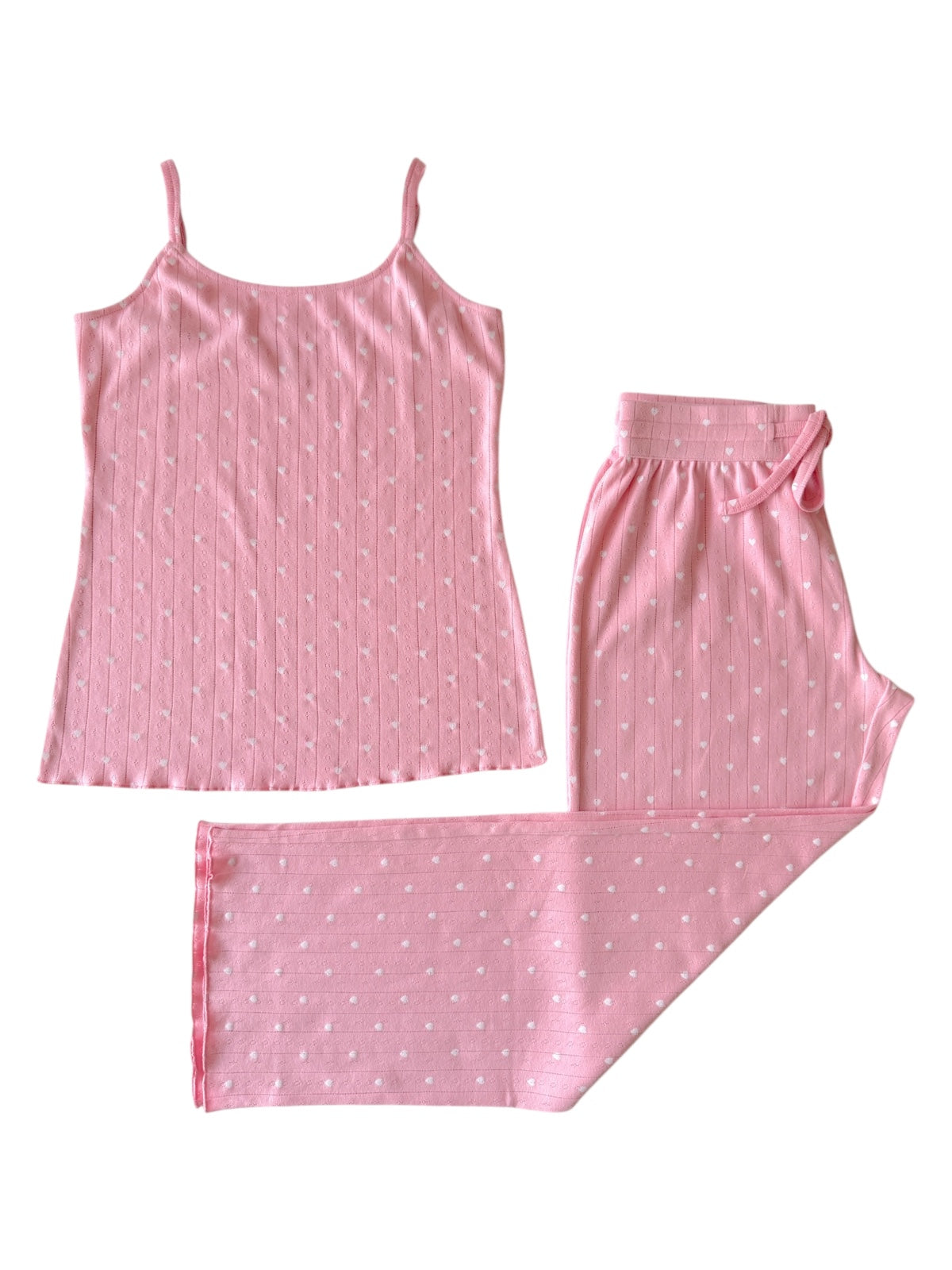 Pink pajama set featuring a sleeveless top and long pants with white polka dots.