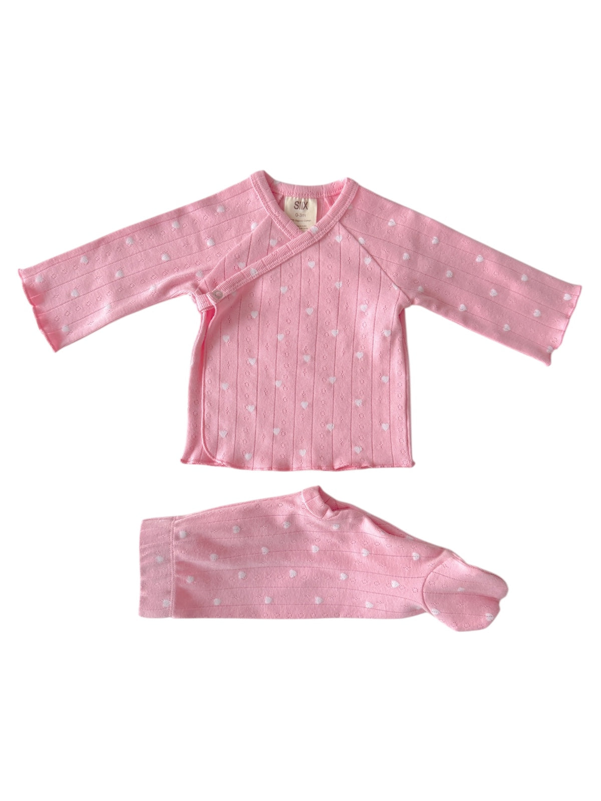 Pink infant outfit with long sleeves and footed pants, featuring a dotted pattern and wrap-around design.