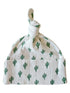 White baby hat with green cactus print and tied top knot design.