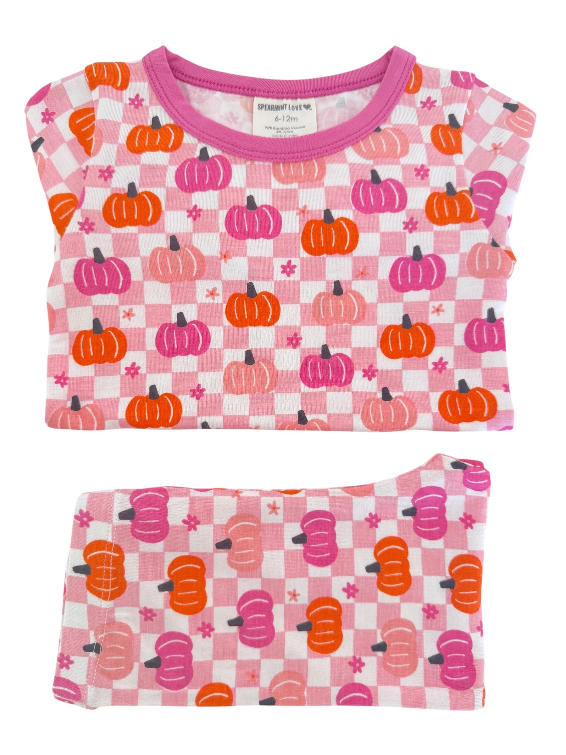 Pink pajama set featuring orange and purple pumpkins on a checkered pattern, size 6-12 months.
