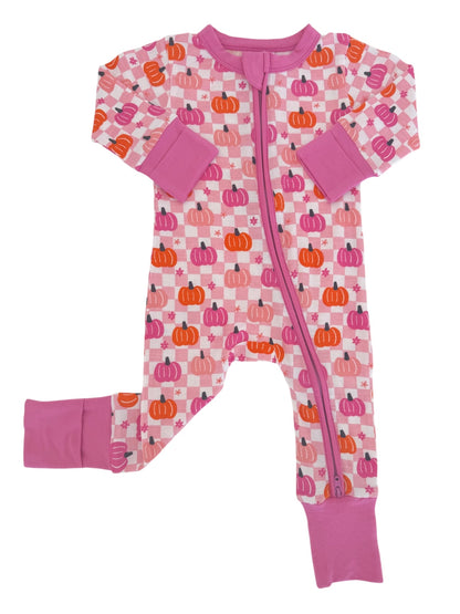 Pink pajama onesie with pumpkin patterns and purple cuffs, featuring a full front zipper.