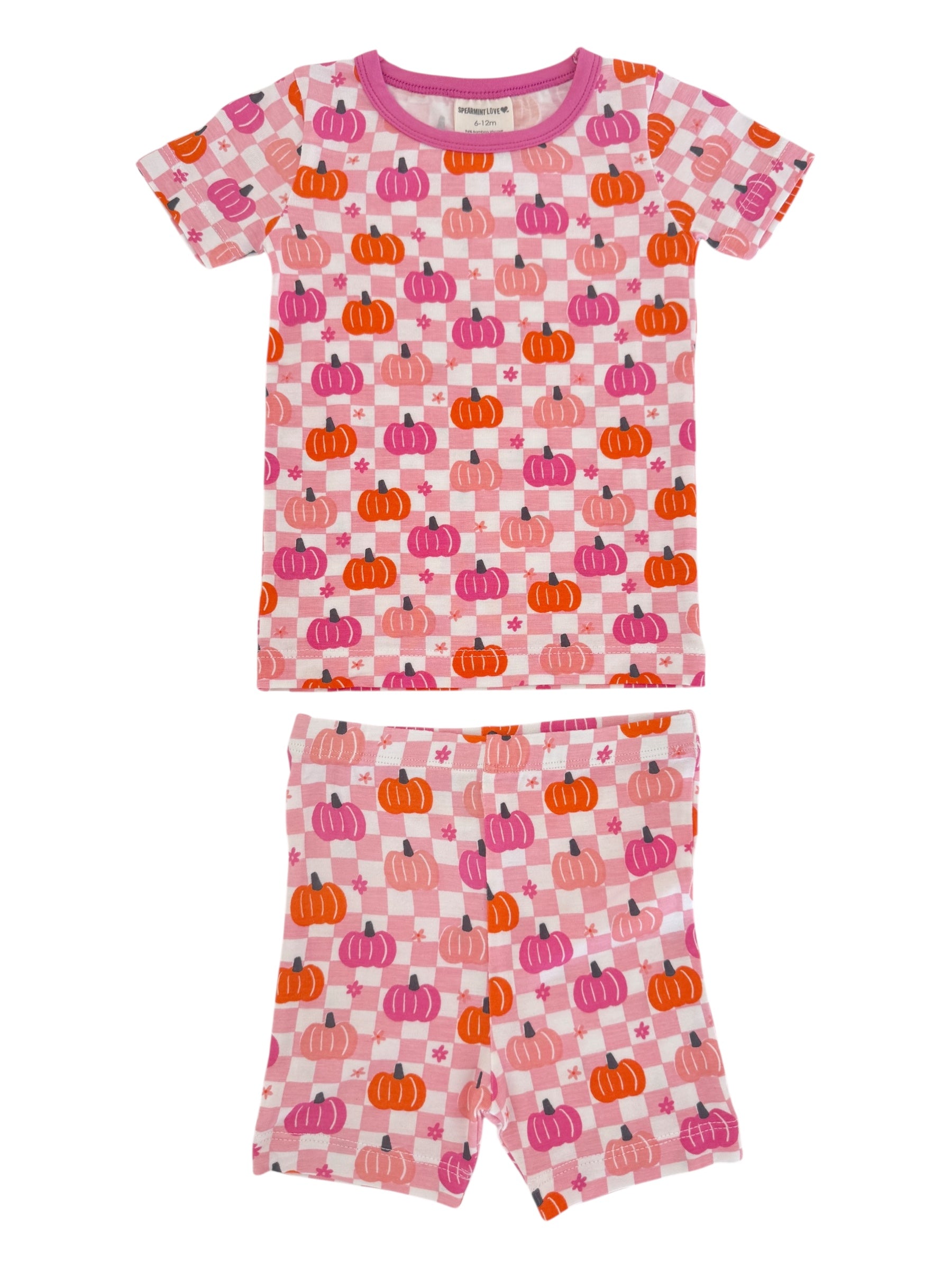 Pink pajamas with colorful pumpkin patterns, featuring a short-sleeve top and matching shorts.