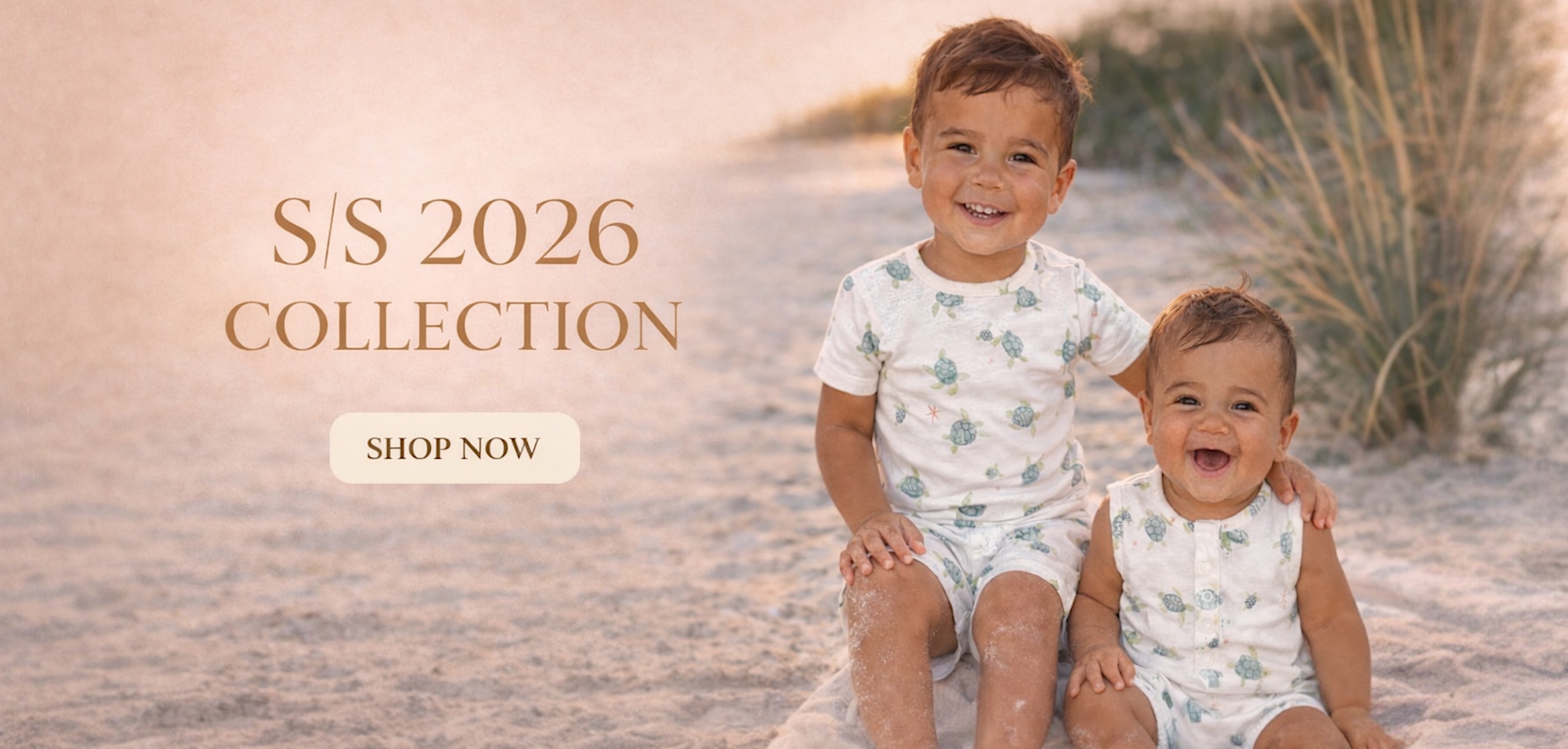Two smiling children in coordinating outfits on a beach, promoting the S/S 2026 collection. "Shop Now" button visible.