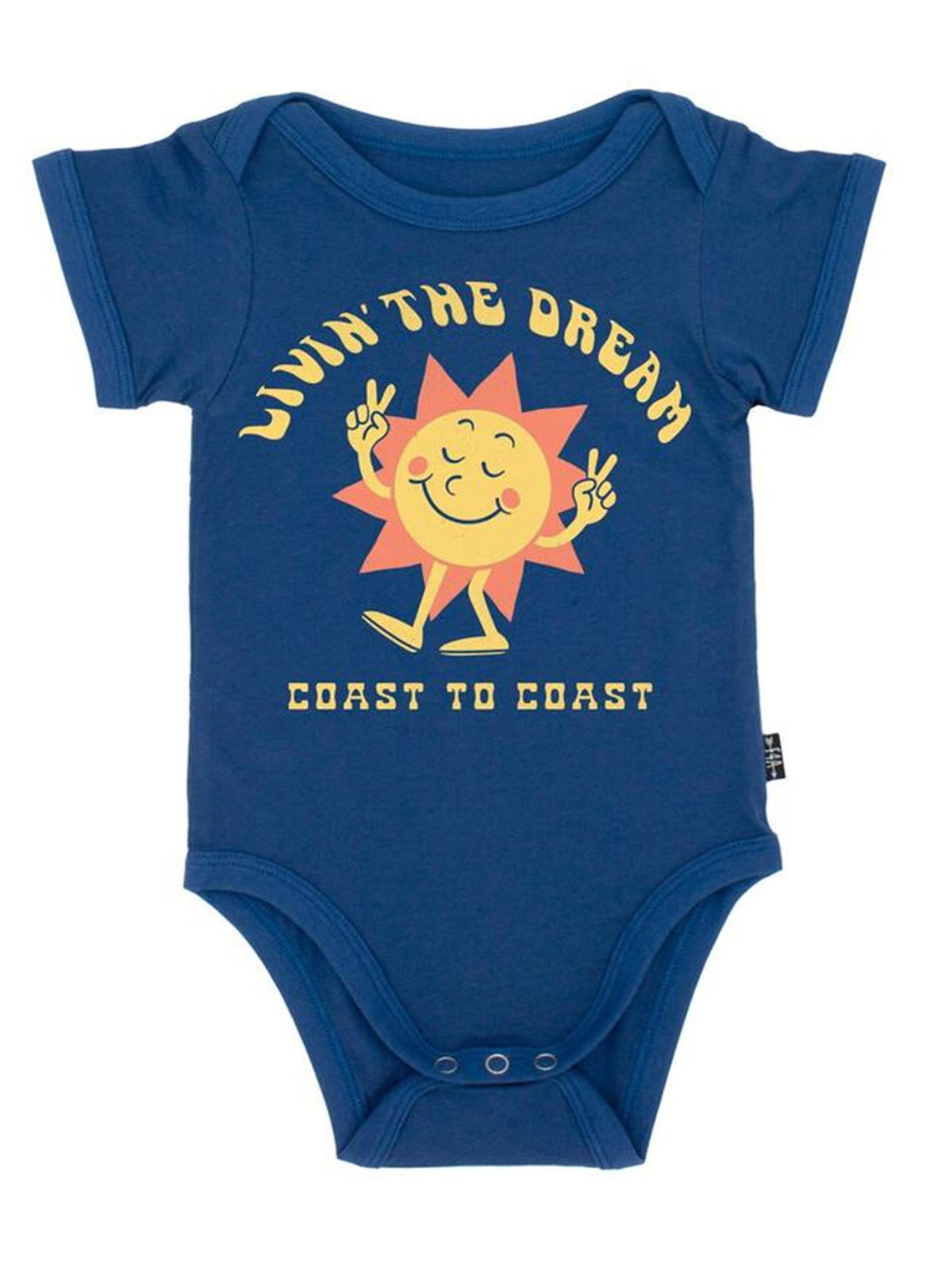 Navy blue baby onesie with a smiling sun graphic and text "Livin' the Dream Coast to Coast" in yellow.