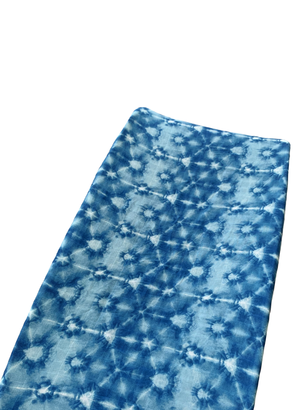 Blue tie-dyed fabric with intricate patterns and textures, laid flat against a white background.