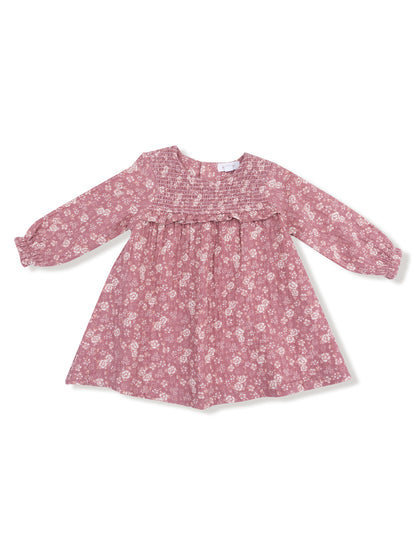 Pink floral dress with long sleeves and smocked bodice, perfect for casual outings or special occasions.