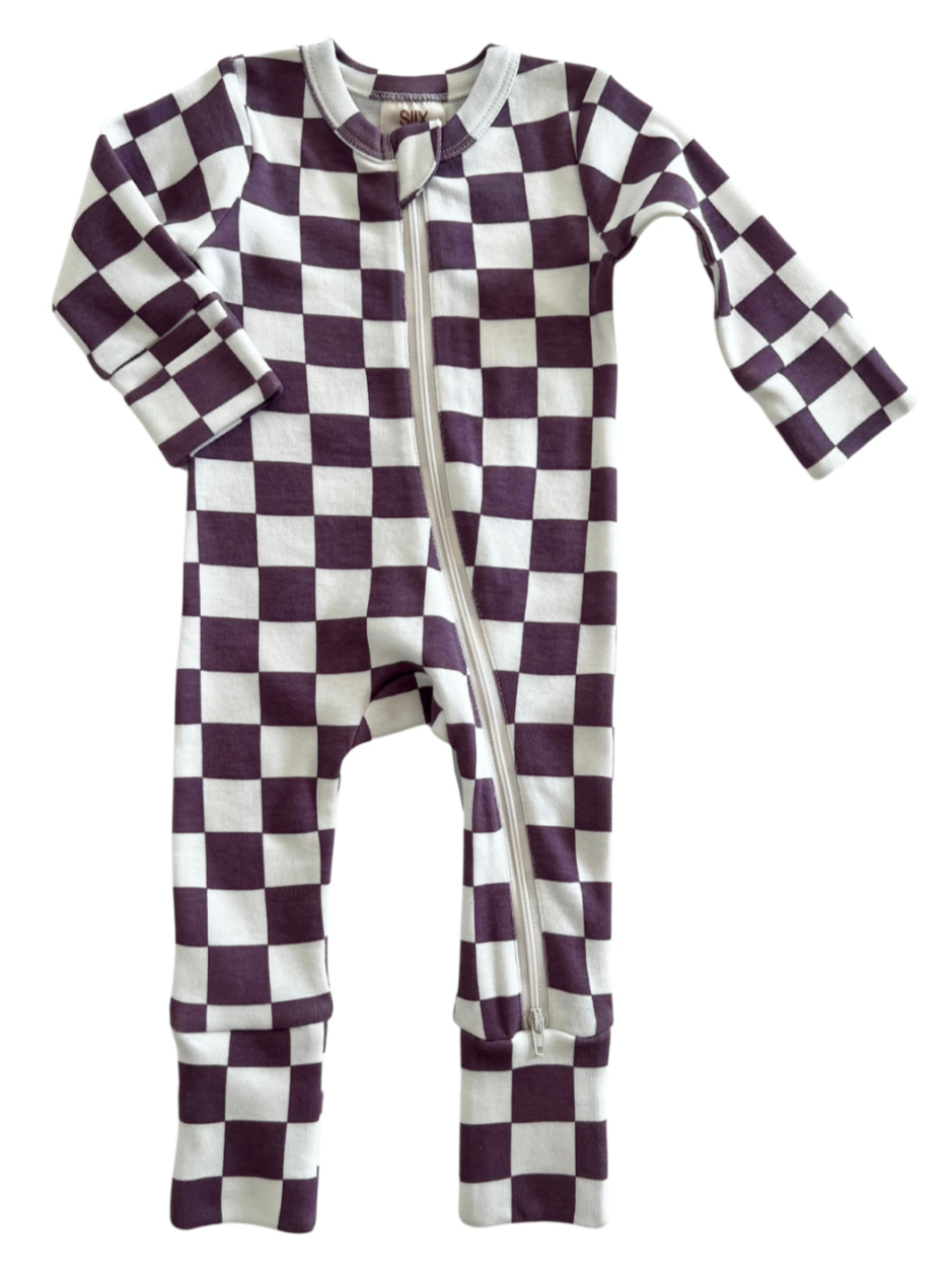 Purple and white checkered children’s onesie with a front zipper and long sleeves.