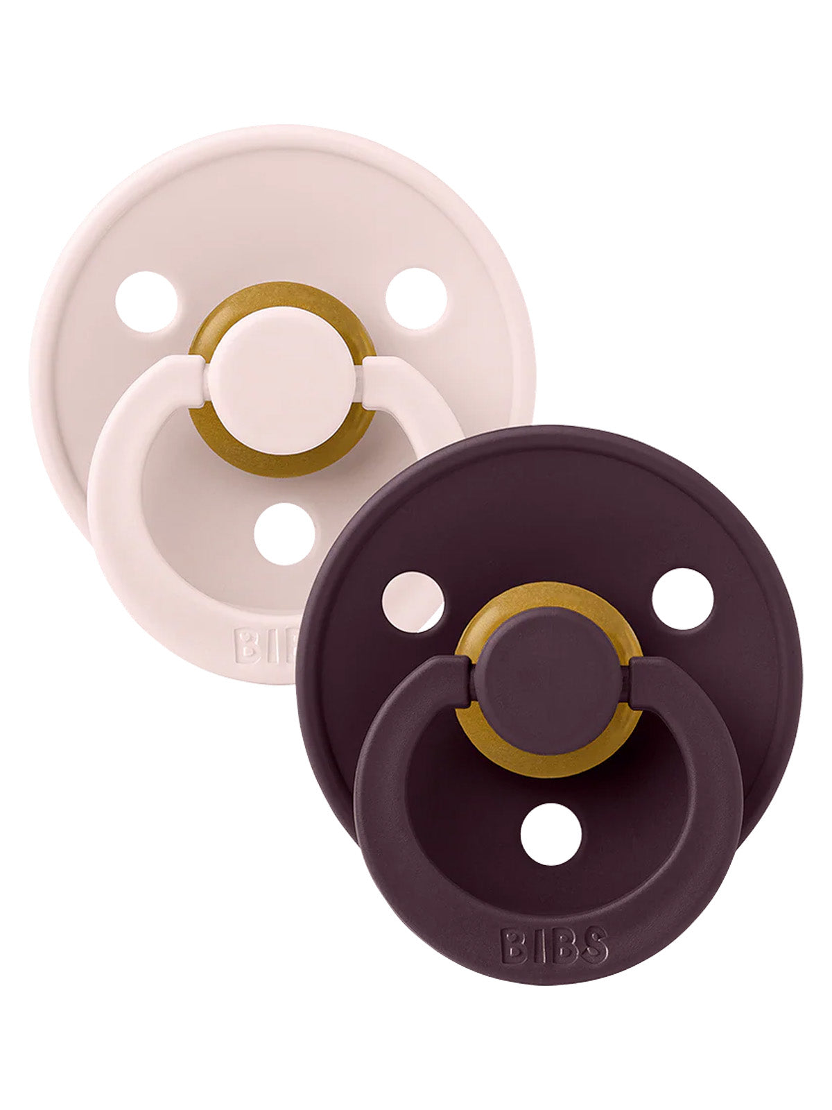 Two pacifiers in beige and dark purple with gold accents, featuring multiple holes for airflow and brand logo.