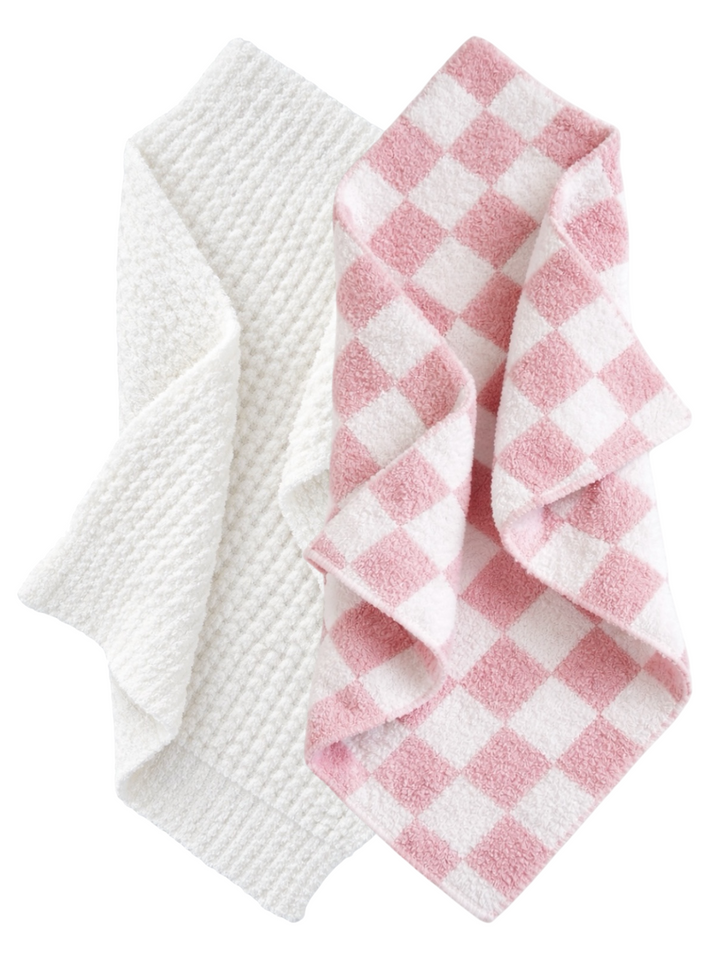 Two textured towels: one white and one pink checkered, overlapping slightly.