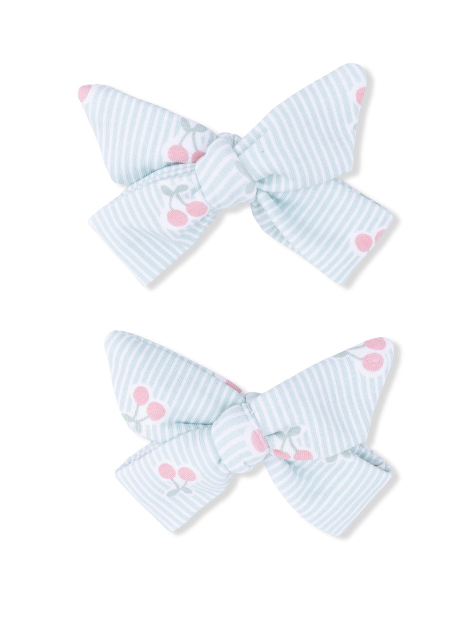Light blue striped hair bows with pink cherry patterns, arranged in a pair.