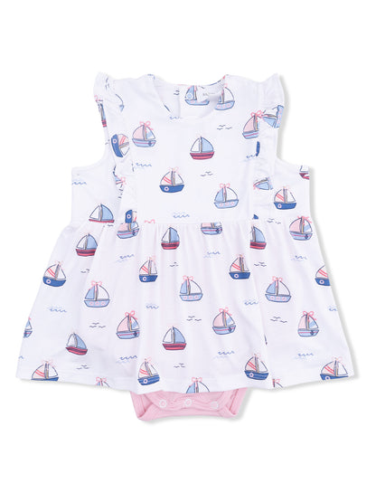 White dress with sailboat pattern, ruffled sleeves, and pink bottom snap closure for infants.