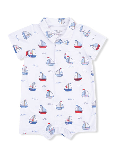 White baby romper with a sailboat pattern in red and blue. Features a collared neckline and a front pocket.