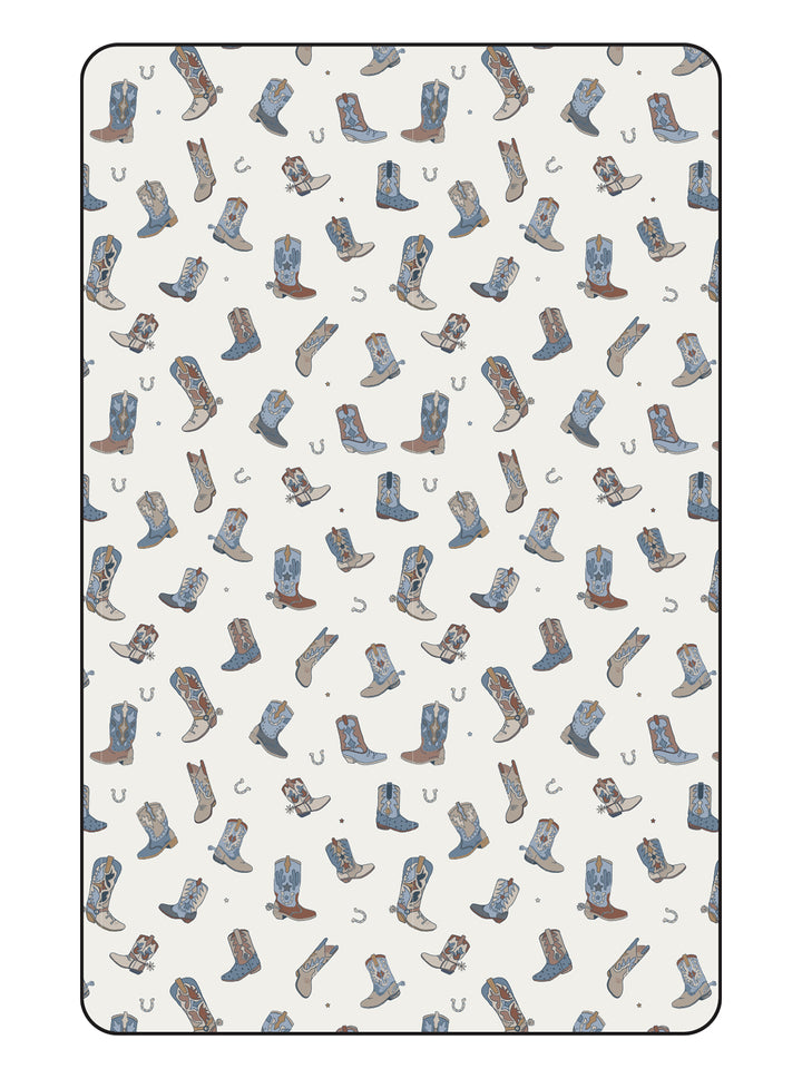 Pattern of various illustrated cowboy boots and horseshoes on a light background.