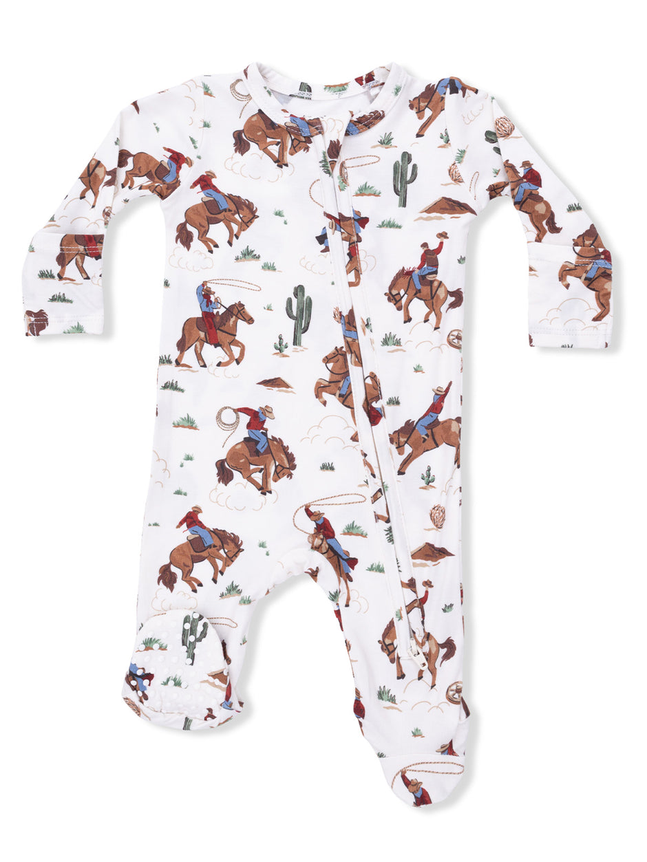 White baby onesie with cowboy and horse print, featuring rodeo themes and cacti designs.