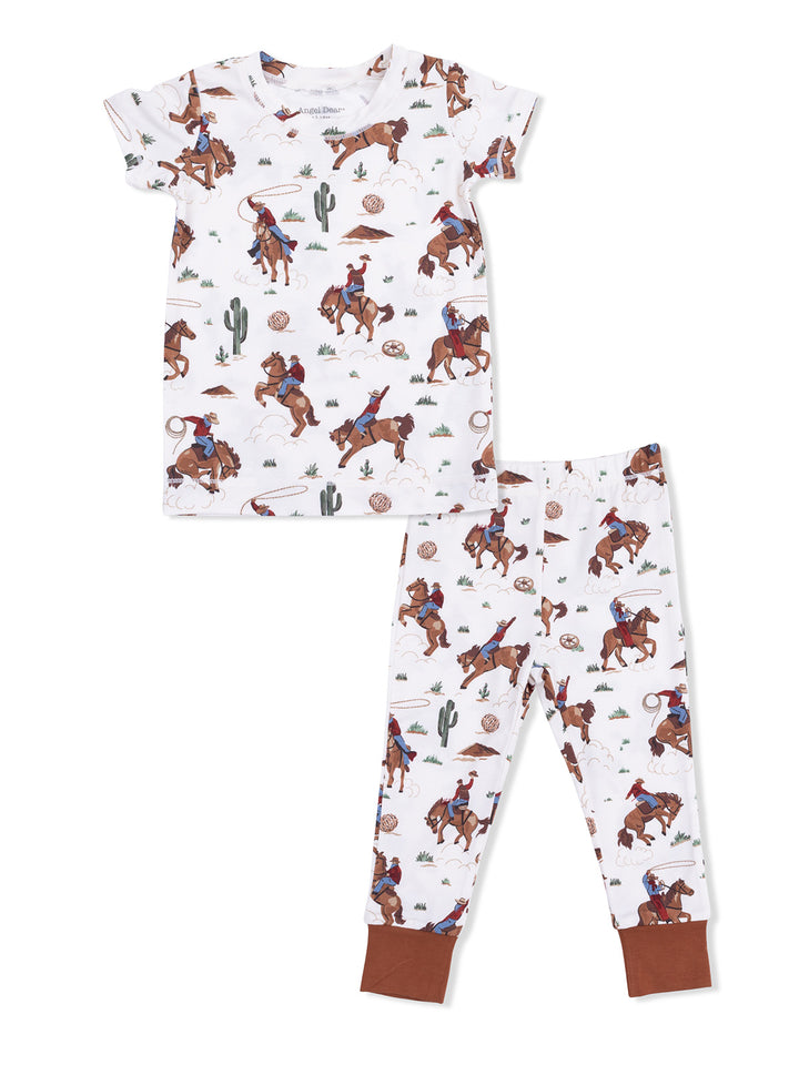 Cowboy-themed kids' pajamas featuring rodeo scenes, cacti, and playful designs on a light background.