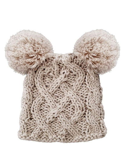 Knit beige winter hat with two fluffy pom-poms on top, featuring a textured cable pattern.