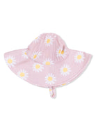 Pink sun hat with white and yellow daisies, featuring a wide brim and adjustable chin strap.